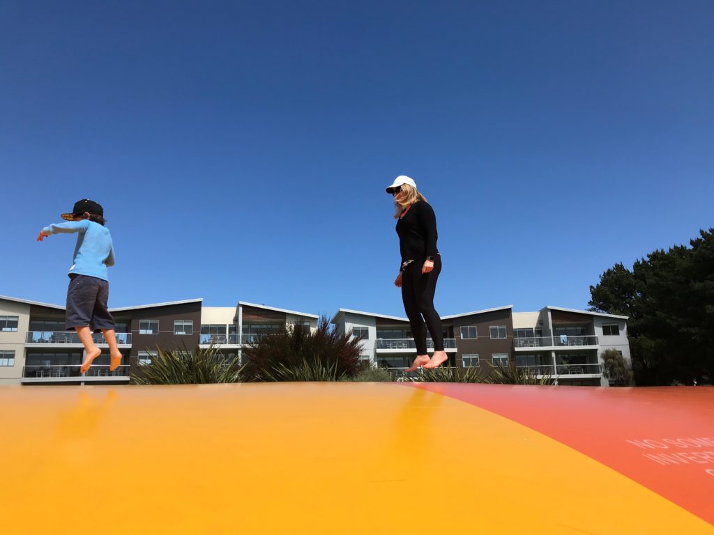 Liz and her son bounce on a trampoline