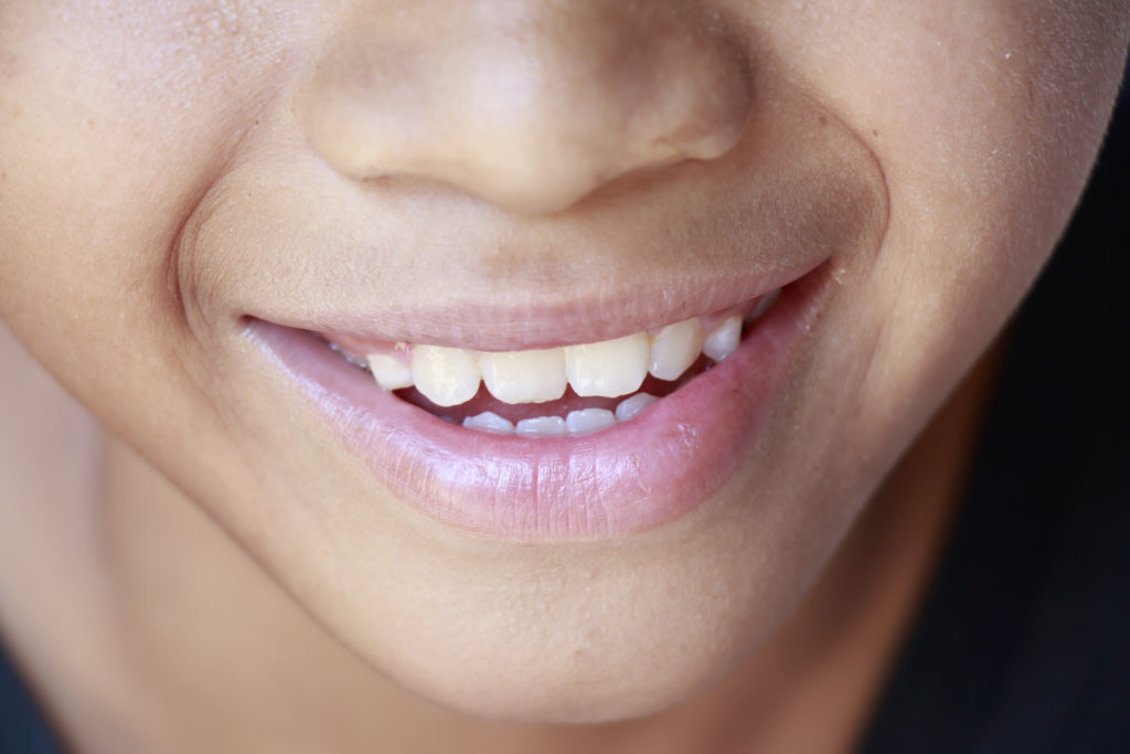 Close up of mouth and nose of smiling child