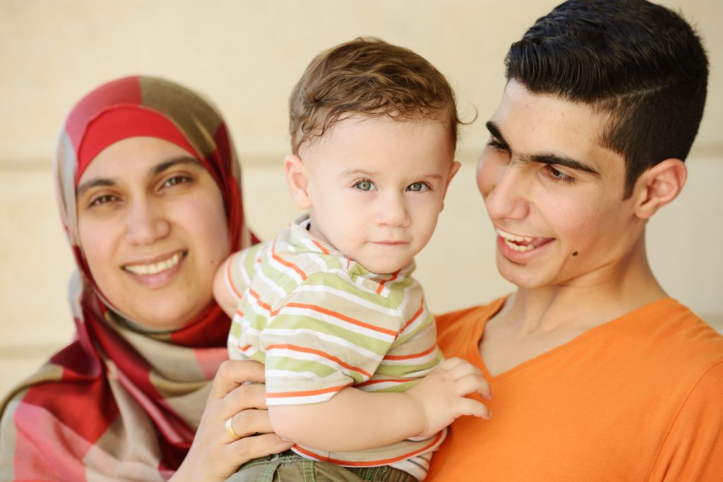 Young muslim couple with baby boy