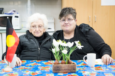Two women smile at camera in Aboriginal social support group