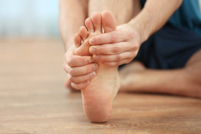 Close up of person rubbing their foot