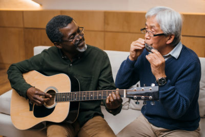 Older men play instruments together