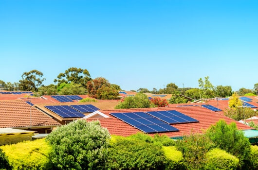 Suburban houses with solar panels on the roofs